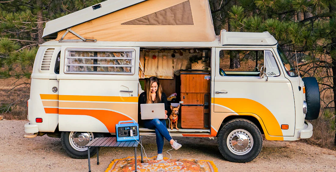 BLUETTI portable power station used beside a camper van for remote work