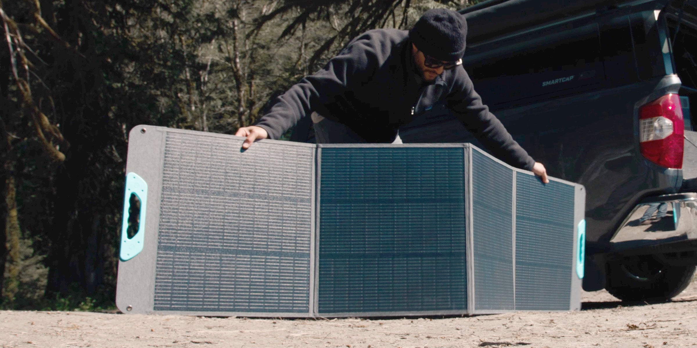 Renogy E.Flex portable solar panel unfolding at camp