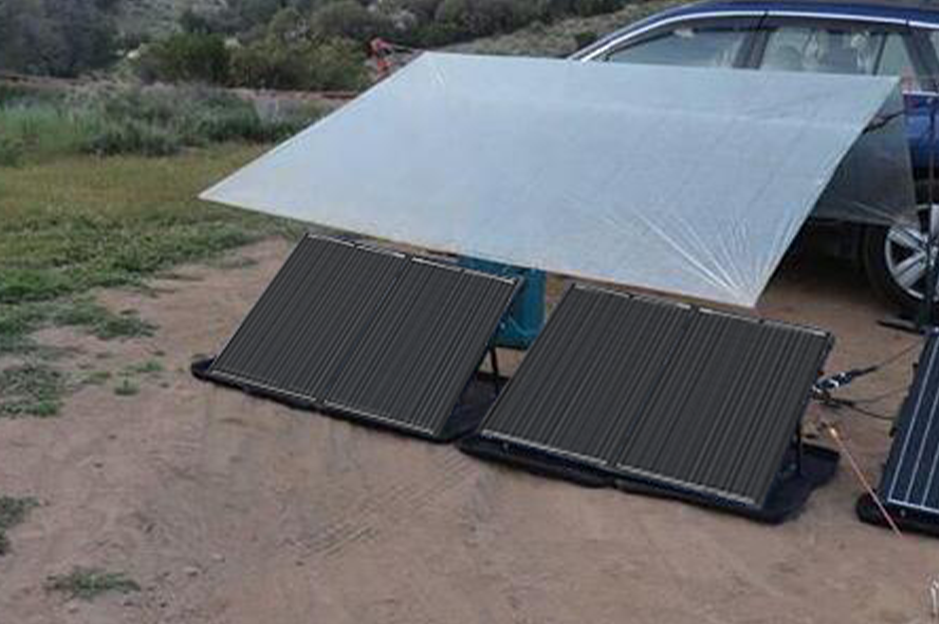 Two Renogy portable solar suitcases deployed at an outdoor campsite