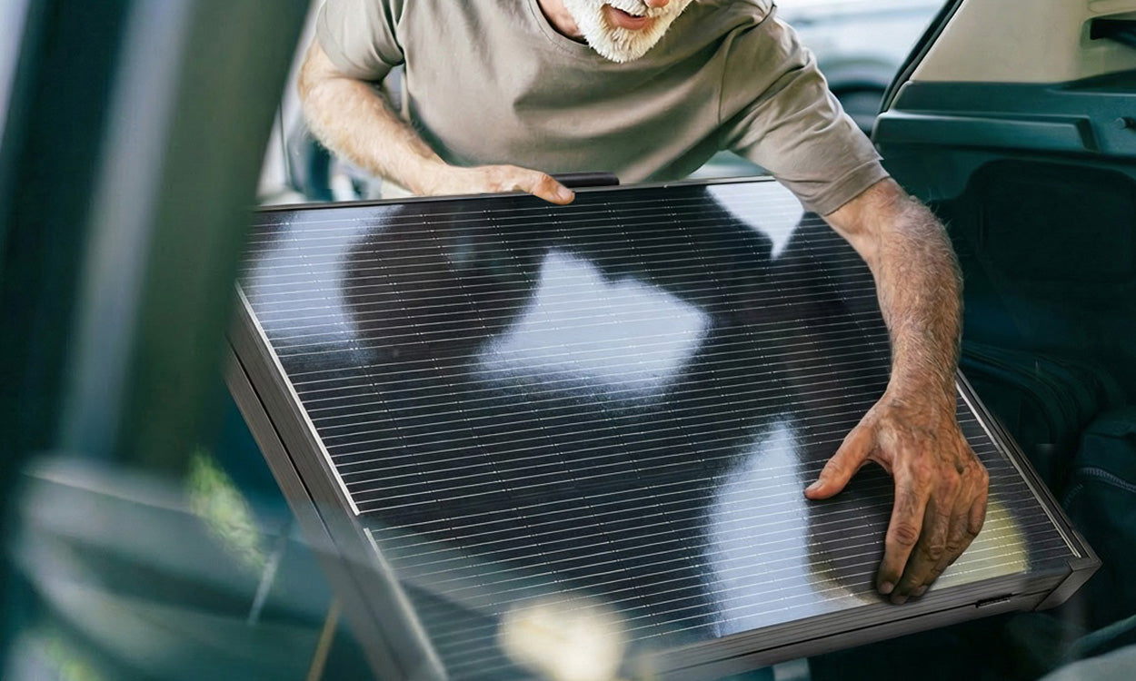Renogy foldable 200W solar suitcase being carried for portable travel use